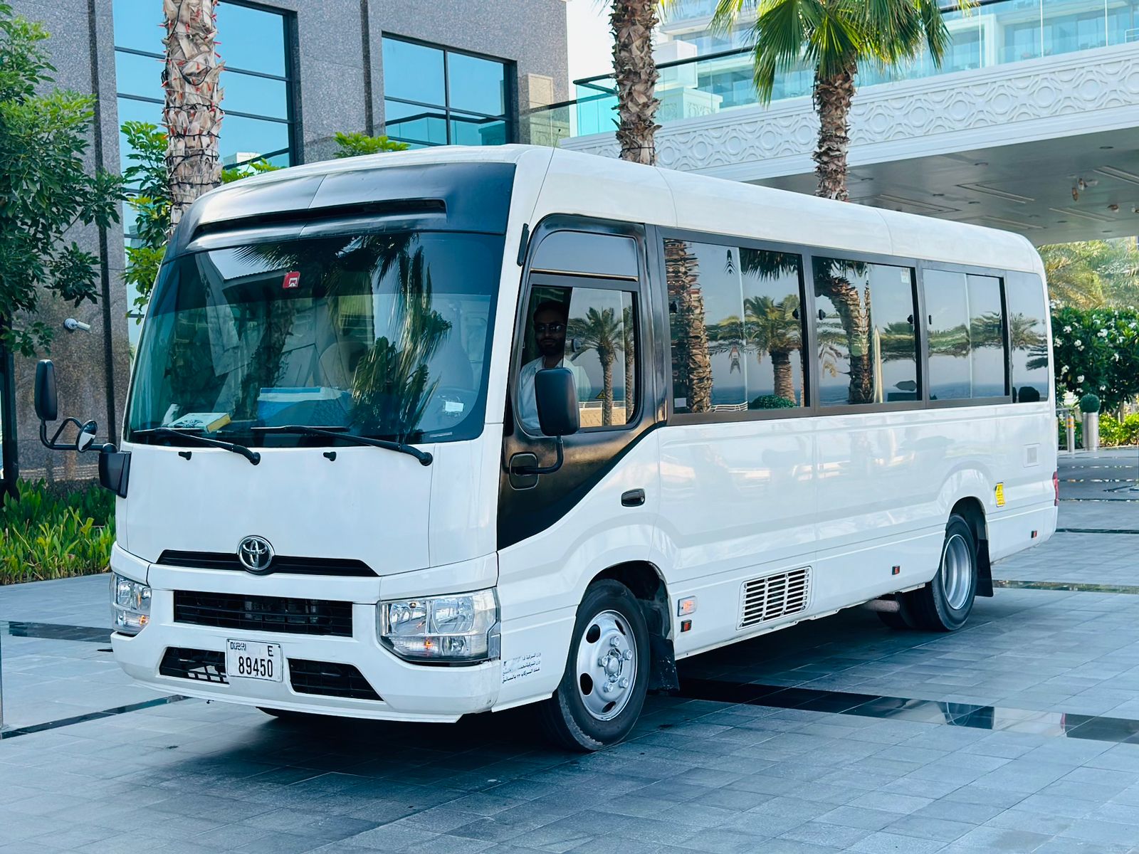 Toyota Coaster mini bus rental in white color in dubai parked